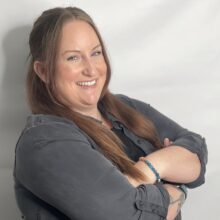 Caucasian female in a grey shirt.