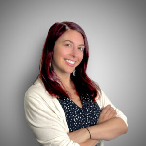 Heather Mastrianno White woman with red hair in a white sweater