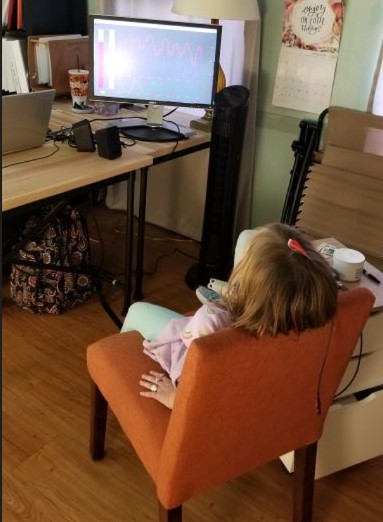 Olivia watching a monitor during the neurofeedback session