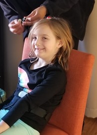 Olivia smiling sitting in a chair