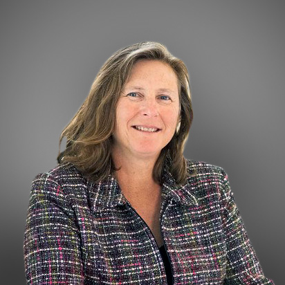 A middle aged woman in a multicolored blazer